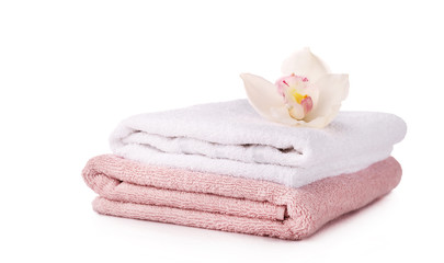 Obraz na płótnie Canvas Bath towels with orvhid flower isolated on white