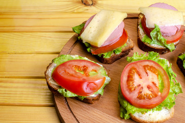 homemade sandwich with vegetables, sausage and cheese