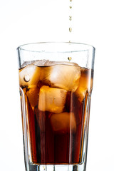 cocktail with ice and cola in a glass on a white background, you can add rum or whiskey