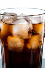 cocktail with ice and cola in a glass on a white background, you can add rum or whiskey