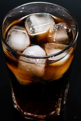 cocktail with ice and cola in a glass on a white background, you can add rum or whiskey