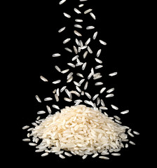 Falling dry rice grains isolated on black background