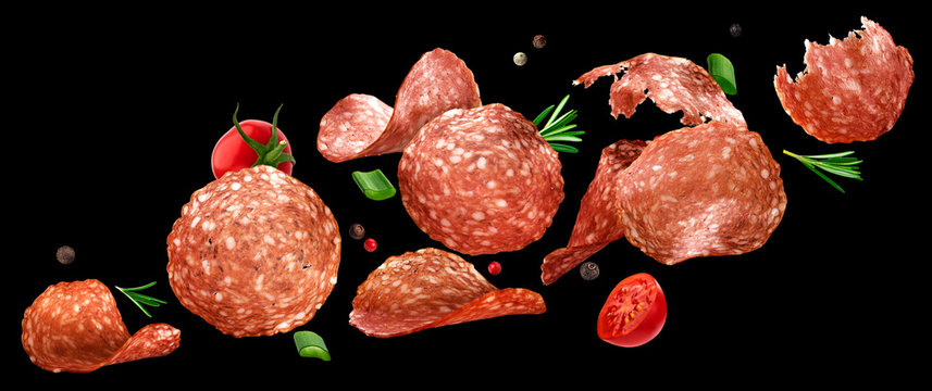 Falling Sliced Salami Isolated On Black Background