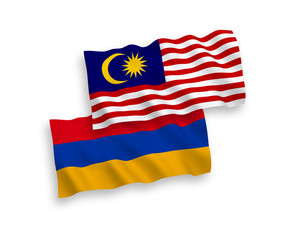 National vector fabric wave flags of Armenia and Malaysia isolated on white background. 1 to 2 proportion.