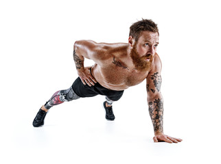 Sporty man does push ups exercise on the floor on his left hand. Photo muscular man isolated on white background. Strength and motivation