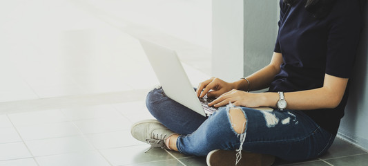 Back to school education knowledge college university concept. Female student study in library using laptop and searching internet
