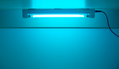 UV lamp sterilization of air and surfaces. Ultraviolet light from the lamp in laboratory....