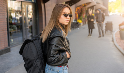 Obraz premium Young Adult caucasian woman backpack street modern style. Summer vacation concept. Beauty fashion. Young people concept. Travel backpack concept. People hiking. Happy female.