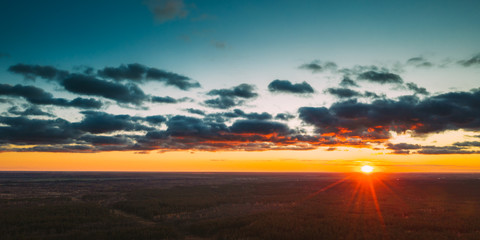 Aerial View Of Sunshine In Sunrise Bright Dramatic Sky. Scenic Colorful Sky At Dawn. Sunset Sky Above Autumn Forest Landscape In Evening. Top View From High Attitude