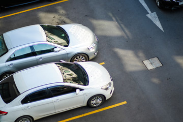 Top view of car parking area on asphalt road