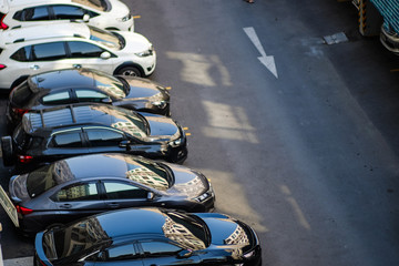 Top view of car parking area on asphalt road