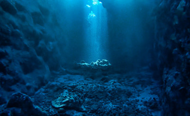 Underwater photo of magic sunlight inside a cave