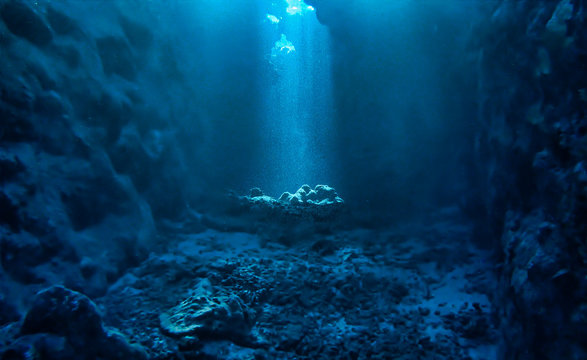 Underwater photo of magic sunlight inside a cave