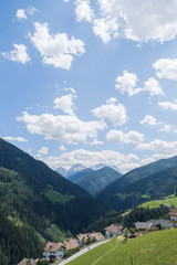 Fototapeta na wymiar Cloudy sky over a valley during summer in Trentino Alto Adige, Italy
