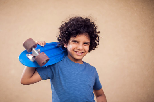 A portrait of happy kid boy holding skateboard. Children,leisure and lifestyle concept