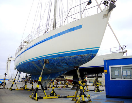 A sailing boat repaired in a boatyard.