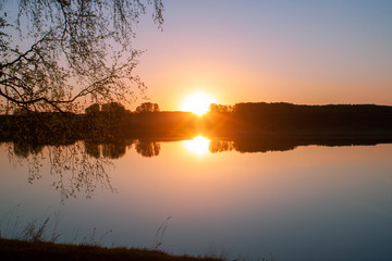 Fototapeta na wymiar beautiful orange sunset over lake