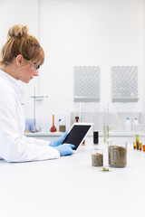 Scientist working on tablet in pharmaceutical laboratory