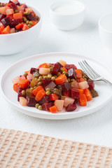 Traditional Russian lean vegetable salad vinaigrette in a white plate...