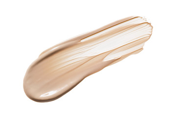 Lliquid foundation cream swatch smear. Light brown makeup concealer smudge isolated on white...