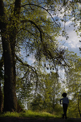 running boy in a beautiful forest. Spring green forest.