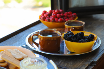 Summer breakfast is served on the terrace. Coffee, cookies with berries and fruits. healthy breakfast outdoors