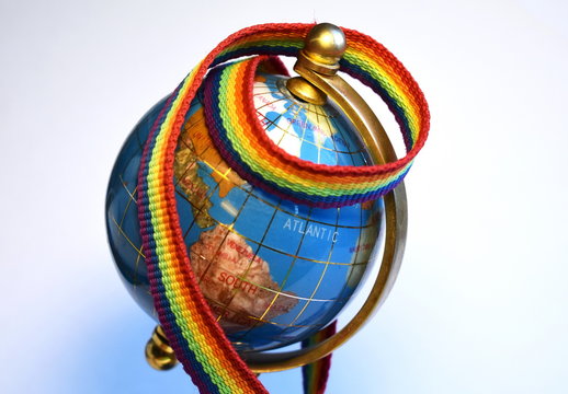 Bright rainbow ribbon on the globe on a white background