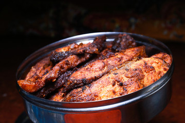 Homemade deeply fried fish in a steel bowl with dark background, delicious fish fry