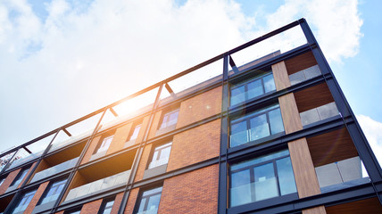 Modern apartment buildings on a sunny day with a blue sky. Facade of a modern apartment building....