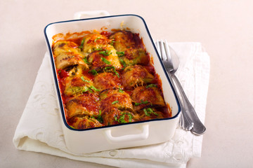 Zucchini rolls with cheese and herb filling baked