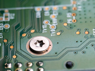 Screw in the form of an asterisk. Hard drive close-up. Green electronic Board.