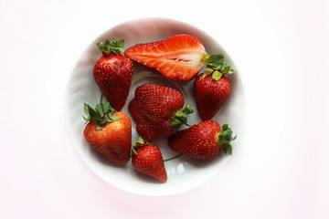 strawberries in a bowl on white background