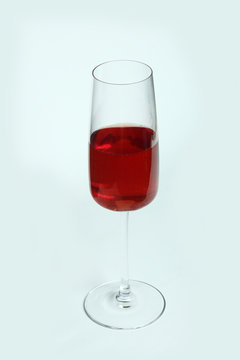 a glass of red wine isolated on white background vertical image