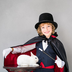 Child illusionist with cute rabbit