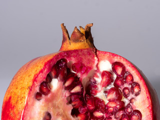 top part of a pomegranate on grey background