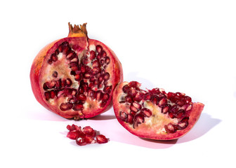 pomegranate with seeds in foreground on a isolated white background