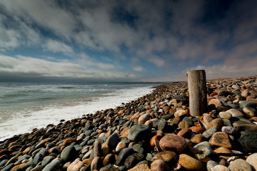 long exposure image of rocks,sea, clouds
