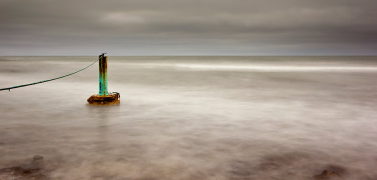 long exposure image of rocks,sea, clouds