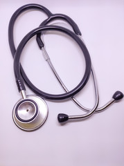 Black stethoscope on white background. Close up