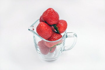 Red fresh strawberry fruit in the glass
