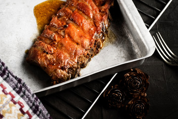Roasted pork rib on a baking sheet and on a rack