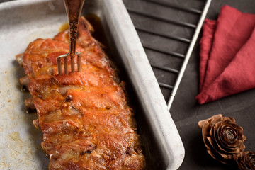 Roasted pork rib on a baking sheet and on a rack