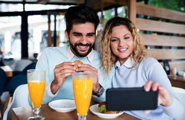 Couple sitting in a cafe, having breakfast. Love, dating, food, lifestyle concept
