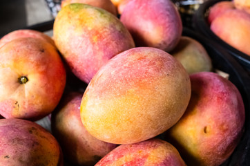 mango fruits in a basket at traditional marketplace