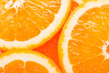 Slices of tropical fruit orange closeup, top view.