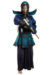 Fototapeta premium Portrait of man kendo fighter with shinai (bamboo sword). Shot in studio. Isolated with clipping path on white background