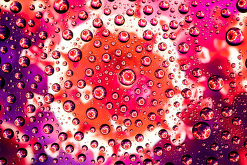 Image of a coronovirus through drops of water on glass