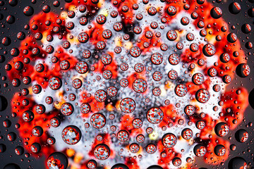Image of a coronovirus through drops of water on glass