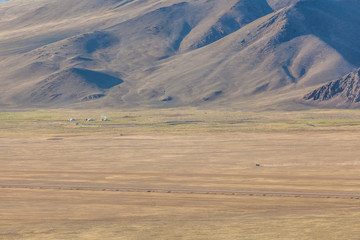 Western Mongolia mountainous landscape. View of nomadic camp.