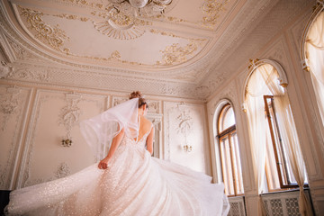 bride spinning in her lush wedding dress with a long train